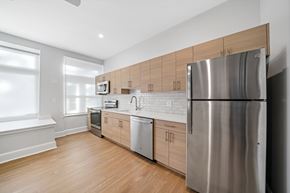 Philadelphia apartment for rent - a kitchen with wooden cabinets and a stainless steel refrigerator